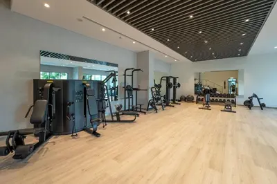 a gym with several treadmills and machines in a room at Serene 1BR Retreat with Pool & Gym by Safa Park in Dubai