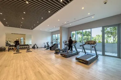 a gym with treadmills and exercise equipment in a room at Serene 1BR Retreat with Pool & Gym by Safa Park in Dubai
