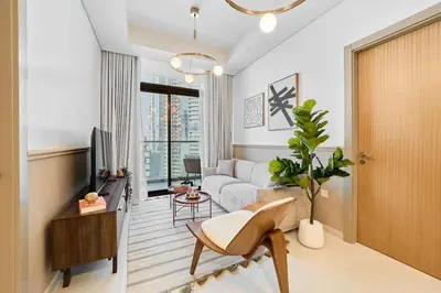 a living room with a couch and a tv at FAM Living - 2 Bedroom Aykon City Dubai in Dubai
