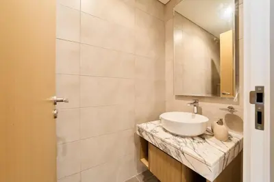 a bathroom with a sink and a mirror at FAM Living - 2 Bedroom Aykon City Dubai in Dubai