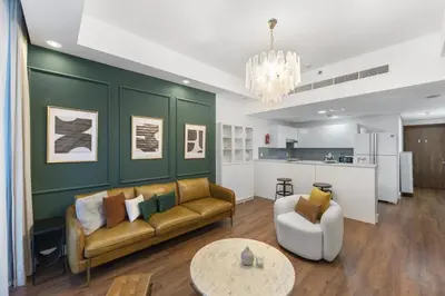 a living room with a couch and a table at Stylish 1BR Canal View & 12 min to Downtown in Dubai