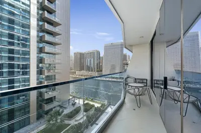 an apartment balcony with a view of the city at Stylish 1BR Canal View & 12 min to Downtown in Dubai