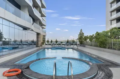 a swimming pool on the side of a building at Stylish 1BR Canal View & 12 min to Downtown in Dubai