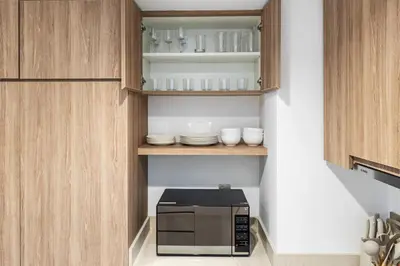 a microwave oven sitting inside of a kitchen at Luxury Suite Huge Terrace Canal and Gevora Views with Infinity Pool in Dubai