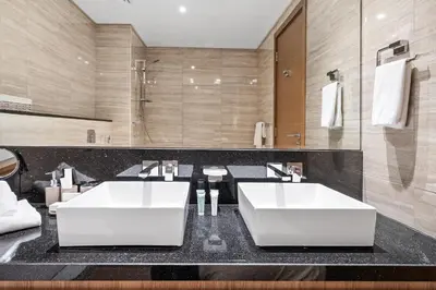 a bathroom with two sinks and a large mirror at Luxury Suite Huge Terrace Canal and Gevora Views with Infinity Pool in Dubai