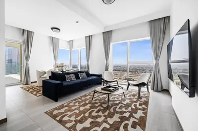 a living room with a couch and chairs and windows at Luxury Suite Huge Terrace Canal and Gevora Views with Infinity Pool in Dubai