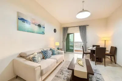 a living room with a couch and a table at Spacious 1BR Apartment Imperial Residence B JVT in Dubai