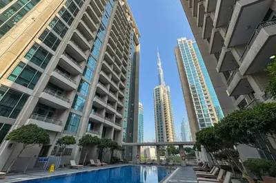 a pool in the middle of a city with tall buildings at Stylish Studio Retreat Heart of Downtown Dubai in Dubai