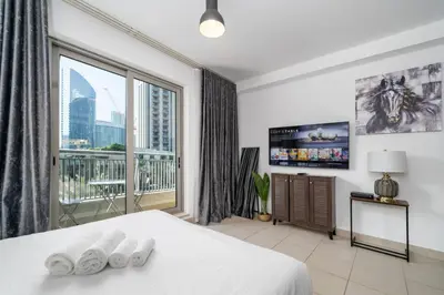 a bedroom with a bed and a large window at Stylish Studio Retreat Heart of Downtown Dubai in Dubai