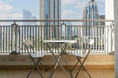 two chairs and a table on a balcony with a view at Stylish Studio Retreat Heart of Downtown Dubai in Dubai