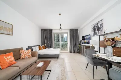a living room with a couch and a table at Stylish Studio Retreat Heart of Downtown Dubai in Dubai