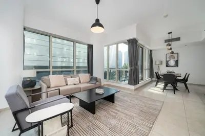 a living room with a couch and a table at Spacious 2 Bedroom plus Office Prime Dubai Marina in Dubai
