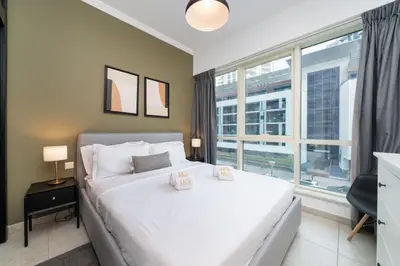 a bedroom with a white bed and a large window at Spacious 2 Bedroom plus Office Prime Dubai Marina in Dubai