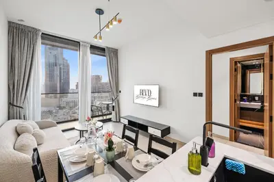 a living room with a couch and a table at BLVD Luxe Stay with Pool Heart of JVC in Dubai