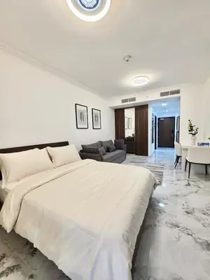 a bedroom with a large bed and a living room at Luxury Studio in JLT near Metro & Lake View in Dubai