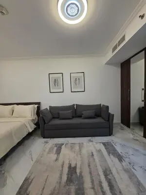a living room with a couch and a bed at Luxury Studio in JLT near Metro & Lake View in Dubai