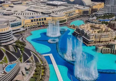 an aerial view of a city with waterfalls at Iconic Burj Khalifa & Fountain Views near Dubai Mall in Dubai