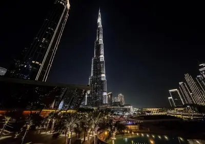 a view of the tallest building in the city at night at Iconic Burj Khalifa & Fountain Views near Dubai Mall in Dubai
