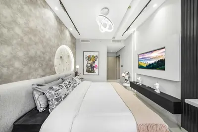 a bedroom with a large bed and a wall at Iconic Burj Khalifa & Fountain Views near Dubai Mall in Dubai