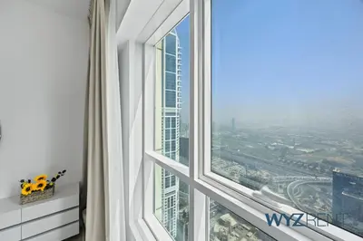 a room with a window with a view of a city at 2BR Aegean Charm Sulafa Tower, Canal View & Gym in Dubai