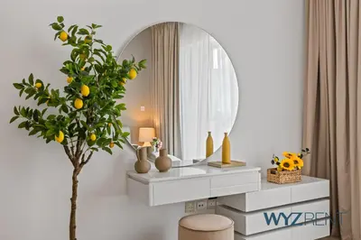 a dressing table with a tree and a mirror at 2BR Aegean Charm Sulafa Tower, Canal View & Gym in Dubai