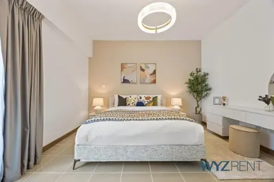 a bedroom with a large bed in a room at 2BR Aegean Charm Sulafa Tower, Canal View & Gym in Dubai