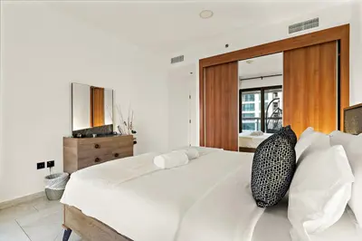 a bedroom with a large white bed with two pillows at FIRST CLASS 1BR Luxury Marina Retreat in Dubai