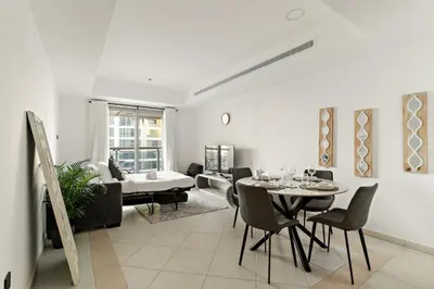 a living room with a table and chairs and a couch at FIRST CLASS 1BR Luxury Marina Retreat in Dubai