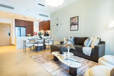 a living room and kitchen with a couch and a table at Seafront 2BR, Within Walking Distance to La Mer Beach, Short Drive Away from Mercato Mall, La Sirene Building 2, La Mer by Deluxe Holiday Homes in Dubai