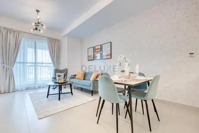 a living room with a table and a couch at Modern 1BR Retreat at Al Khail Heights, Al Quoz by Deluxe Holiday Homes in Dubai