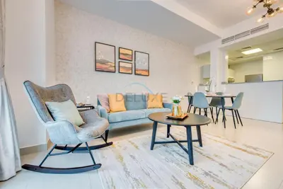 a living room with a couch and a table at Modern 1BR Retreat at Al Khail Heights, Al Quoz by Deluxe Holiday Homes in Dubai