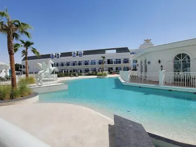 a large swimming pool in front of a building at Miracle Luxury Studio in Dubai