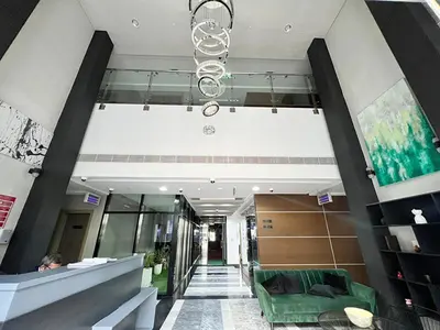 a lobby with a green couch in a building at Dubai heaven in Dubai