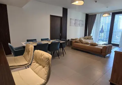 a living room with a table and a couch at Luxury stay at Downtown Dubai-Walk to Burj Khalifa in Dubai