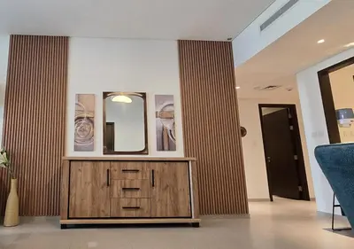 a room with a wooden dresser and a mirror at Luxury stay at Downtown Dubai-Walk to Burj Khalifa in Dubai