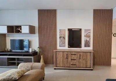 a living room with a tv and a couch at Luxury stay at Downtown Dubai-Walk to Burj Khalifa in Dubai
