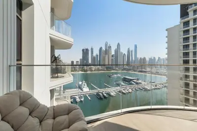 a view of a marina from a balcony in a building at Stylish 2BR Beachfront Pool&Gym Access in Dubai