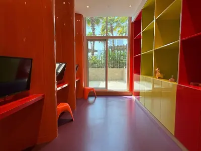 a living room with a tv and a large window at Mahenti · Luxury Living at Its Finest in Dubai