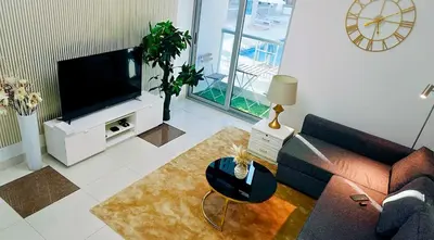 a living room with a couch and a tv at Stylish Marina Stay Near Bla Bla club & JBR Walk in Dubai