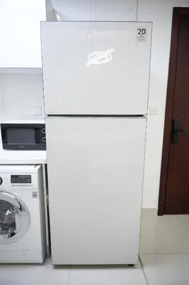 a white refrigerator in a kitchen next to a washing machine at Stylish Marina Stay Near Bla Bla club & JBR Walk in Dubai