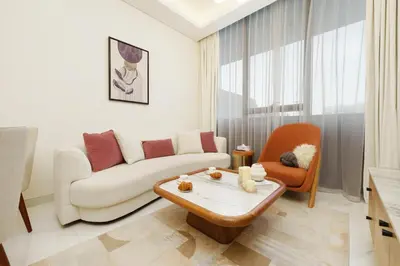 a living room with a couch and a coffee table at Private Pool Stylish 1BR Arjan in Dubai