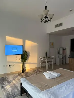 a bedroom with a bed and a tv on the wall at Luxury Stay - Walk to Dubai Mall & Burj Khalifa 21 in Dubai