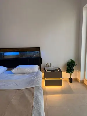 a bedroom with a bed and a potted plant at Luxury Stay - Walk to Dubai Mall & Burj Khalifa 21 in Dubai