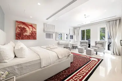 a white bedroom with a large bed and a red rug at Villa with Private Pool in Palm Jumeirah in Dubai