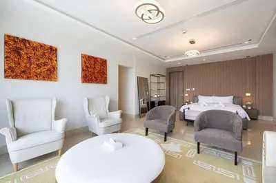 a hotel room with a bed and chairs at Villa with Private Pool in Palm Jumeirah in Dubai