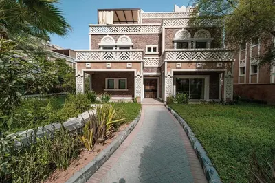 a large brick house with a walkway in front of it at Villa with Private Pool in Palm Jumeirah in Dubai