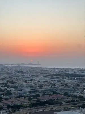 a view of a city at sunset at ag tower in Dubai
