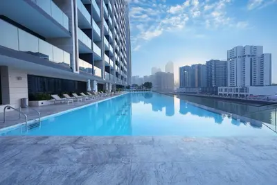 a swimming pool on the roof of a building at Designer Studio Retreat with Jacuzzi & Canal Views in Dubai