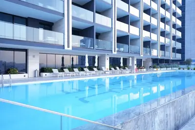 an image of a swimming pool in a building at Designer Studio Retreat with Jacuzzi & Canal Views in Dubai