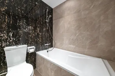 a bathroom with a toilet and a bath tub at Front Burj View - 6min to Dubai Mall - Pool - Gym in Dubai